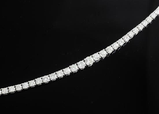A modern 18ct white gold and diamond line bracelet, 17.5cm.